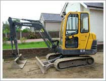 Remove the existing driveway surface using a mini digger